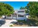 Charming single-story home featuring white siding, brown shutters, a well-maintained yard, and a concrete driveway at 649 Ave J Nw, Winter Haven, FL 33881