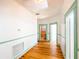 Hallway features fresh paint, hardwood floors, and doorways leading to other rooms at 649 Ave J Nw, Winter Haven, FL 33881