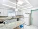 Bright kitchen features white cabinets, granite countertops, modern appliances, and a center island at 649 Ave J Nw, Winter Haven, FL 33881
