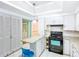 A well-lit kitchen with white cabinets, granite countertops and a black range at 649 Ave J Nw, Winter Haven, FL 33881