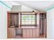 A cozy room with wooden cabinets, a sink, and a large window with a view at 649 Ave J Nw, Winter Haven, FL 33881