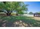 Backyard with large trees and a storage shed at 6529 Farris Dr, Lakeland, FL 33811