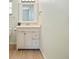 Bathroom featuring a modern white vanity with a marble top and stylish fixtures at 6529 Farris Dr, Lakeland, FL 33811