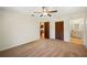 Bedroom with neutral carpet, a ceiling fan, and access to the ensuite bathroom at 6529 Farris Dr, Lakeland, FL 33811