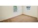 Bright bedroom with two windows and neutral carpeting at 6529 Farris Dr, Lakeland, FL 33811