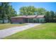 Charming single-story home with a well-manicured lawn and long driveway at 6529 Farris Dr, Lakeland, FL 33811