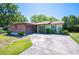 Inviting single-story home with an attached garage and lush green surroundings at 6529 Farris Dr, Lakeland, FL 33811