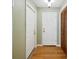 Hallway with hardwood floors, closet and front door at 6529 Farris Dr, Lakeland, FL 33811