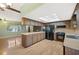 Open kitchen with wooden cabinets, hardwood floors, and black appliances at 6529 Farris Dr, Lakeland, FL 33811