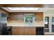 Bright kitchen featuring wood cabinets, a window view, and access to the patio at 6529 Farris Dr, Lakeland, FL 33811