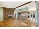 Open living room with hardwood floors, brick fireplace, and natural light at 6529 Farris Dr, Lakeland, FL 33811