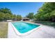 Backyard pool with concrete deck and mature trees at 6529 Farris Dr, Lakeland, FL 33811