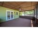 Screened in porch with ceiling fan and exterior door at 6529 Farris Dr, Lakeland, FL 33811