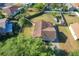 Aerial view of home with fenced yard, mature trees, and landscaping, showcasing the property's curb appeal and outdoor space at 737 Kensington St, Lakeland, FL 33803
