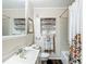 Bathroom with sink, toilet, and shower tub combination with storage at 737 Kensington St, Lakeland, FL 33803