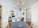 Elegant dining room featuring a crystal chandelier and seamless flow into the bright living room at 737 Kensington St, Lakeland, FL 33803