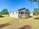 Single-story home with gray siding and a small, covered porch with fresh landscaping at 737 Kensington St, Lakeland, FL 33803
