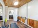 Bright home gym boasting wood plank ceilings, wood-trimmed walls, a mirror, and easy access to an adjacent bathroom at 737 Kensington St, Lakeland, FL 33803