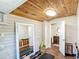 Home gym featuring wood plank ceiling, ample workout space with equipment, and a convenient doorway to an adjoining bathroom at 737 Kensington St, Lakeland, FL 33803