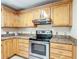 Spacious kitchen features stainless steel oven, wood cabinets, and granite countertops at 737 Kensington St, Lakeland, FL 33803