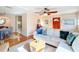 Bright living room featuring hardwood floors, stylish furniture, and a view into the dining area at 737 Kensington St, Lakeland, FL 33803