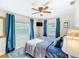 Bright main bedroom with two windows, ceiling fan, and wood flooring at 737 Kensington St, Lakeland, FL 33803