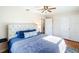 Bright main bedroom with tufted headboard, wood flooring, and closet storage at 737 Kensington St, Lakeland, FL 33803