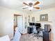 Well-lit office features modern ceiling fan, guitars, computer setup, and a neutral color scheme, perfect for a home office or study at 737 Kensington St, Lakeland, FL 33803