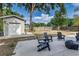 A spacious backyard with wood chairs, large shade tree and storage shed at 746 Mississippi Ave, Lakeland, FL 33801