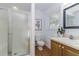 Cozy bathroom featuring glass enclosed shower, vanity and soft lighting at 746 Mississippi Ave, Lakeland, FL 33801