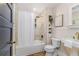 Charming bathroom featuring a tub/shower, pedestal sink, and unique shelving at 746 Mississippi Ave, Lakeland, FL 33801