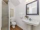 Clean bathroom with shower, pedestal sink, and wood-look flooring at 746 Mississippi Ave, Lakeland, FL 33801
