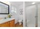 This well lit bathroom features a glass enclosed shower, vanity and soft lighting at 746 Mississippi Ave, Lakeland, FL 33801