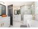 Elegant bathroom with a soaking tub, glass shower, and stylish vanity with modern fixtures at 746 Mississippi Ave, Lakeland, FL 33801