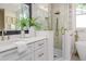 Bathroom featuring dual vanity, glass shower and soaking tub at 746 Mississippi Ave, Lakeland, FL 33801