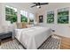 Bright bedroom featuring a large bed, bedside tables, and picturesque views at 746 Mississippi Ave, Lakeland, FL 33801