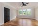 Bright bedroom boasts hardwood floors, large windows, and a stylish ceiling fan at 746 Mississippi Ave, Lakeland, FL 33801