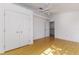 This light-filled bedroom features wood floors, closet and an open door leading to stairs at 746 Mississippi Ave, Lakeland, FL 33801