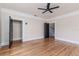 Large bedroom showcasing hardwood floors, closet, and stairway access at 746 Mississippi Ave, Lakeland, FL 33801