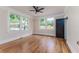Bright bedroom with hardwood floors, multiple windows, and a modern ceiling fan at 746 Mississippi Ave, Lakeland, FL 33801