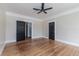 Spacious bedroom showcasing hardwood floors, two closets, and an open doorway at 746 Mississippi Ave, Lakeland, FL 33801