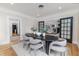 Stylish dining room with modern table, chairs, and black framed glass doors at 746 Mississippi Ave, Lakeland, FL 33801
