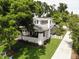 An exterior shot shows a lovely two-story home with white picket fence, lush greenery, and a welcoming front porch at 746 Mississippi Ave, Lakeland, FL 33801