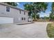 View of a two-story home with a two-car garage, ample parking, and extra storage building at 746 Mississippi Ave, Lakeland, FL 33801