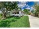 Charming home featuring a well-manicured lawn, mature trees, and quaint front porch perfect for relaxing at 746 Mississippi Ave, Lakeland, FL 33801