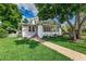 Charming home featuring a brick walkway, well-manicured lawn, and inviting front porch with white brick accents at 746 Mississippi Ave, Lakeland, FL 33801