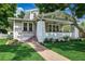 Charming home featuring a brick walkway, well-manicured lawn, and inviting front porch with white brick accents at 746 Mississippi Ave, Lakeland, FL 33801