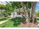 Well-maintained home with a lush lawn, mature trees, and a quaint front porch perfect for relaxing at 746 Mississippi Ave, Lakeland, FL 33801