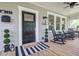 Inviting front porch featuring rocking chairs, stylish decor, and a welcoming entrance to the home at 746 Mississippi Ave, Lakeland, FL 33801
