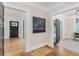 Hallway view with refinished hardwood floors and modern black doors and neutral paint at 746 Mississippi Ave, Lakeland, FL 33801